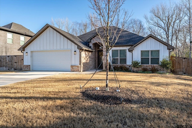 view of front of house featuring board and batten siding, fence, brick siding, and driveway