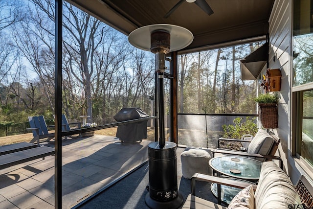 sunroom featuring ceiling fan