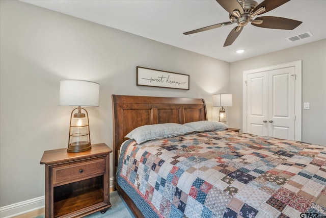 bedroom with a closet, visible vents, baseboards, and ceiling fan