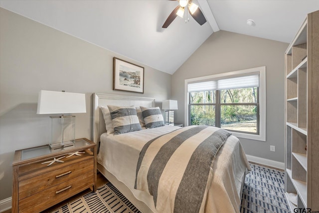 bedroom featuring vaulted ceiling, wood finished floors, baseboards, and ceiling fan