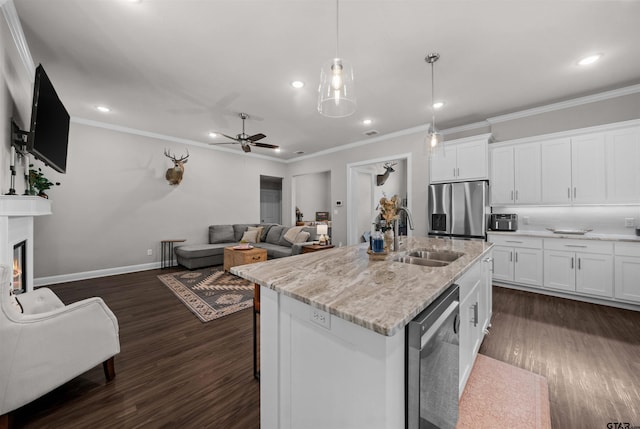 409 Meadow Ln, Chandler, TX 75758 - kitchen with appliances with stainless steel finishes, ornamental molding, dark wood-style flooring, open floor plan, and ceiling fan