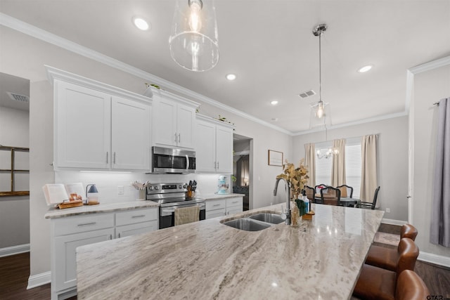 409 Meadow Ln, Chandler, TX 75758 - kitchen featuring stainless steel appliances, an island with sink, dark wood-type flooring, white cabinetry, and backsplash
