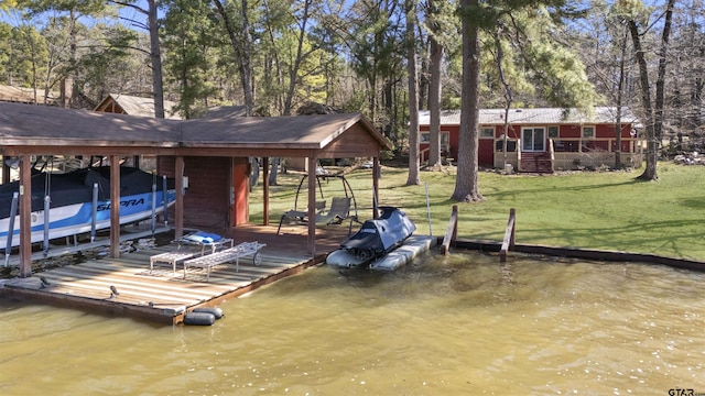 dock area featuring a water view, boat lift, and a yard