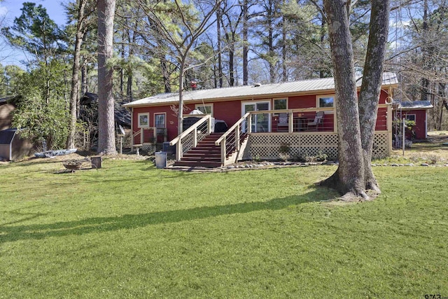 view of front facade featuring a deck, a front lawn, and stairs