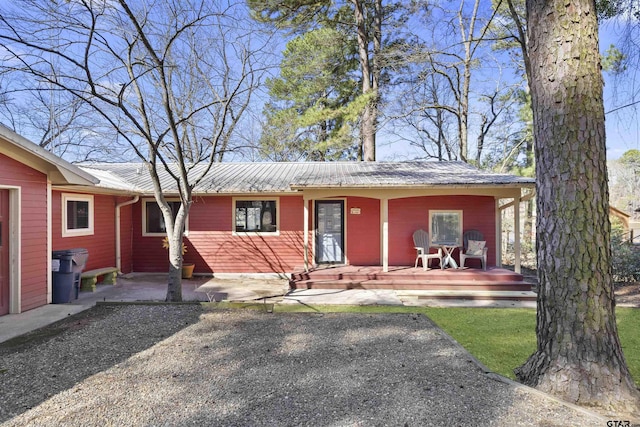 ranch-style home featuring metal roof