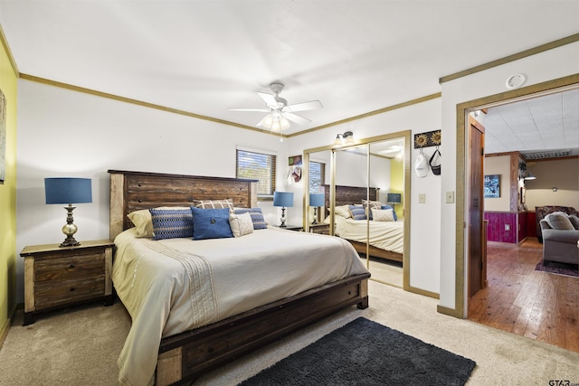 bedroom with carpet floors, ceiling fan, baseboards, and crown molding