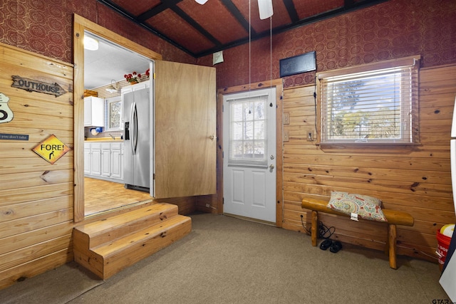 mudroom with light carpet, wood walls, and a ceiling fan