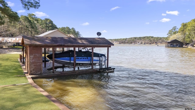 view of dock featuring a water view, a lawn, and boat lift