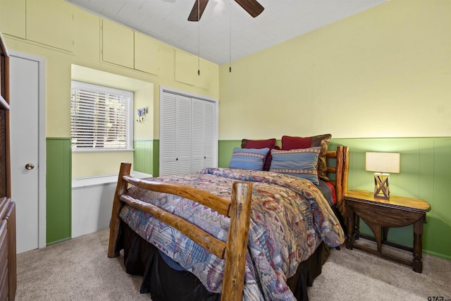 bedroom featuring light carpet, ceiling fan, and a closet