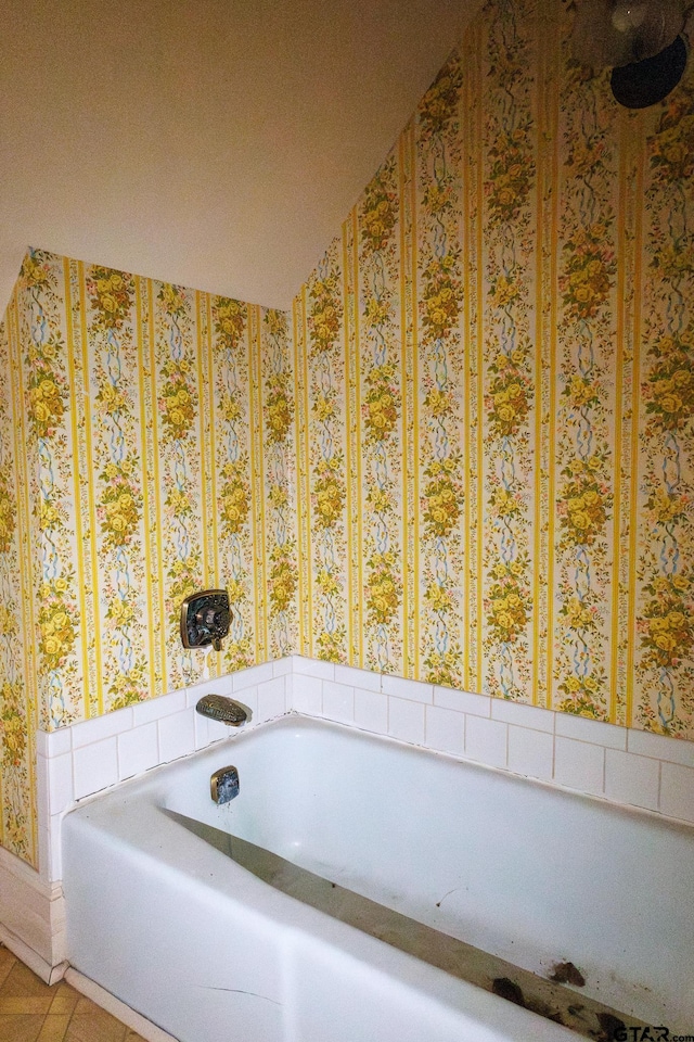 bathroom with a bathtub and tile patterned floors