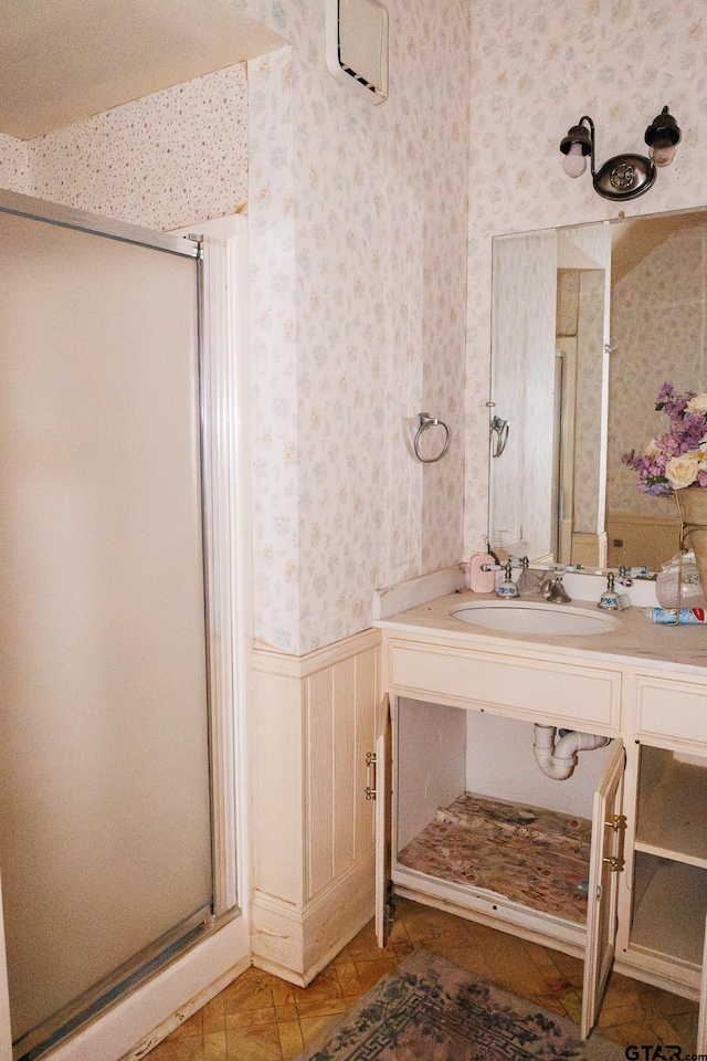 bathroom featuring sink, an enclosed shower, and tile patterned flooring