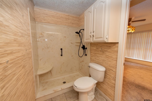 bathroom with a shower, a textured ceiling, tile patterned floors, and toilet