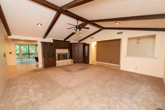 unfurnished living room with lofted ceiling with beams, ceiling fan, light carpet, and a textured ceiling