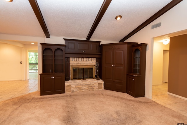 unfurnished living room featuring a fireplace, a textured ceiling, vaulted ceiling with beams, and light tile patterned floors