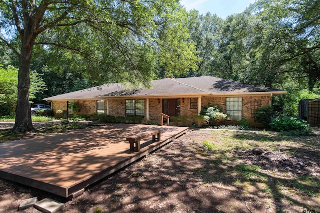 ranch-style home featuring a wooden deck