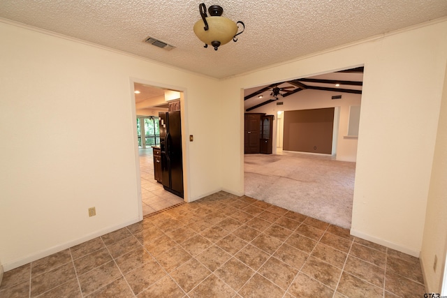 spare room with carpet, a textured ceiling, lofted ceiling with beams, and ceiling fan