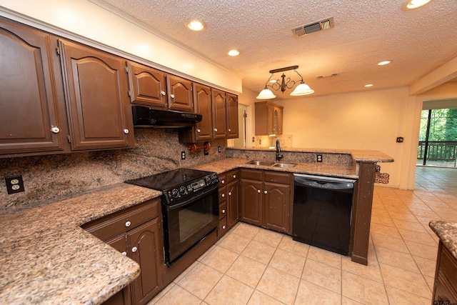 kitchen featuring kitchen peninsula, backsplash, sink, black appliances, and hanging light fixtures