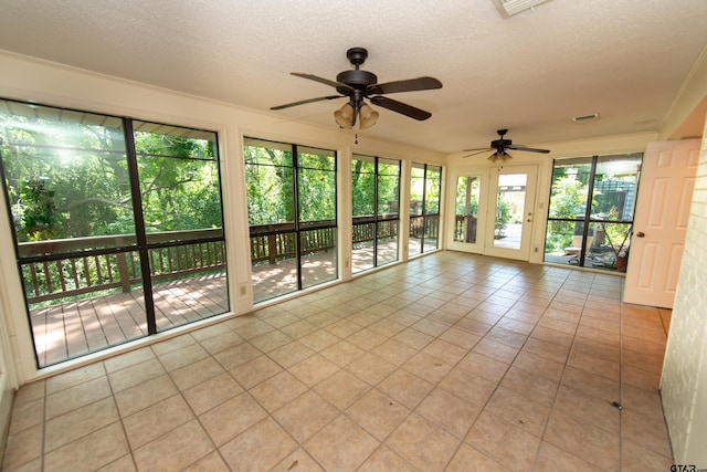 unfurnished sunroom featuring plenty of natural light and ceiling fan