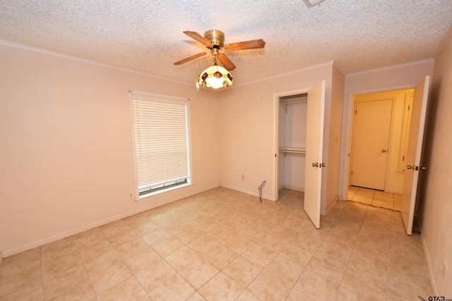 unfurnished bedroom with a closet, ceiling fan, crown molding, and a textured ceiling