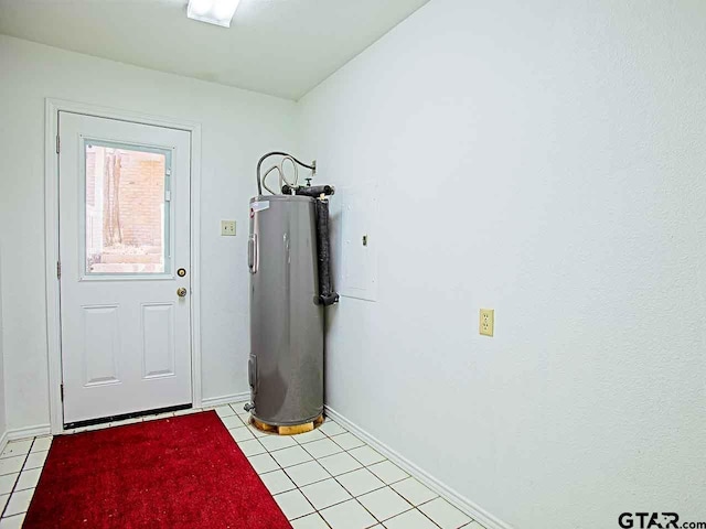 doorway with electric water heater and light tile patterned floors