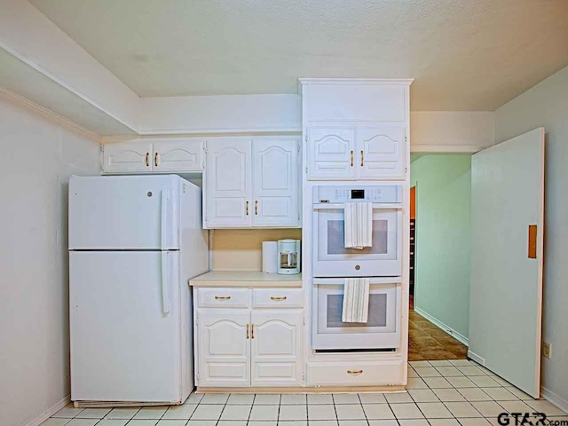 kitchen featuring white cabinetry, white appliances, and light tile patterned floors