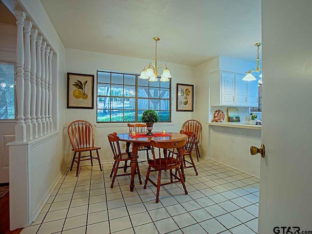 tiled dining area featuring an inviting chandelier