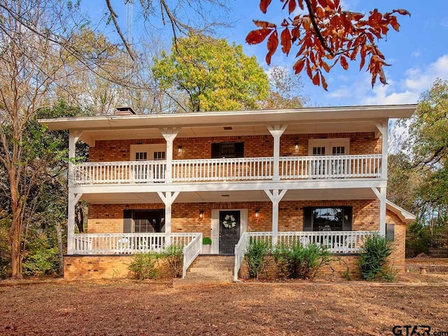 view of front of house featuring covered porch and a balcony