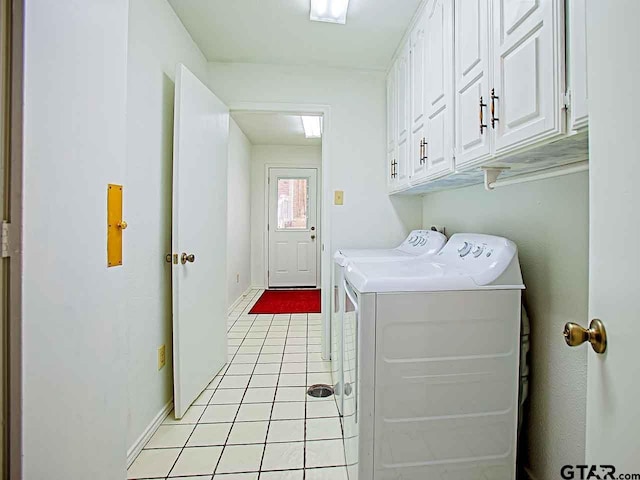 washroom featuring cabinets, washer and dryer, and light tile patterned floors