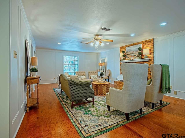 living room with hardwood / wood-style flooring and ceiling fan