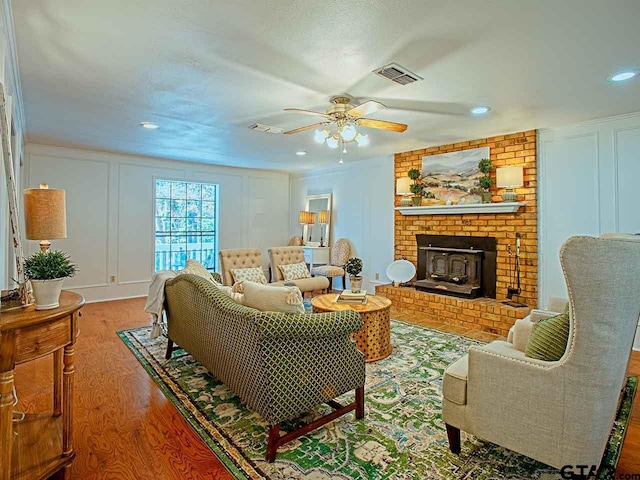 living room featuring wood-type flooring and ceiling fan