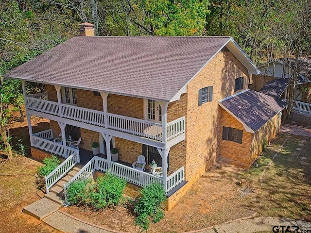 rear view of house featuring a balcony