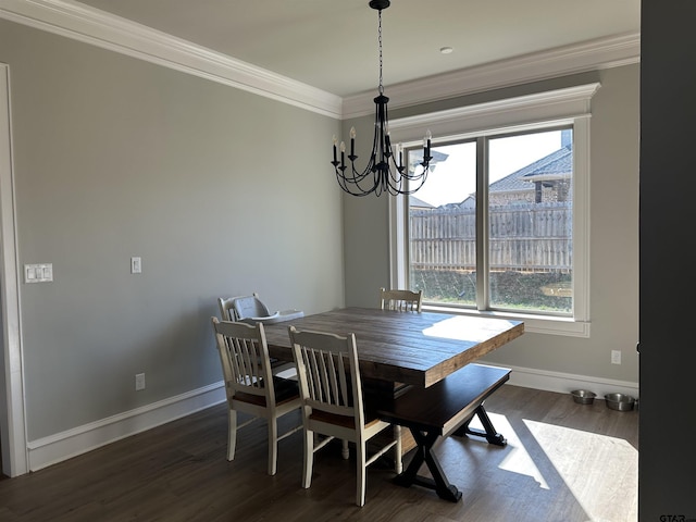 dining room with an inviting chandelier, dark wood-style floors, baseboards, and ornamental molding