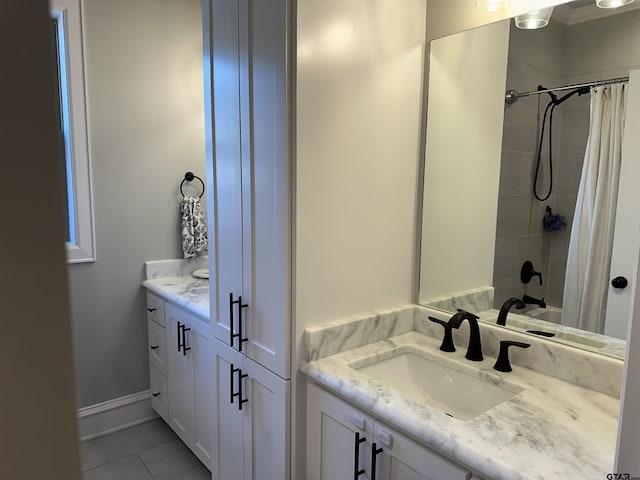 full bath with tile patterned floors, baseboards, and vanity