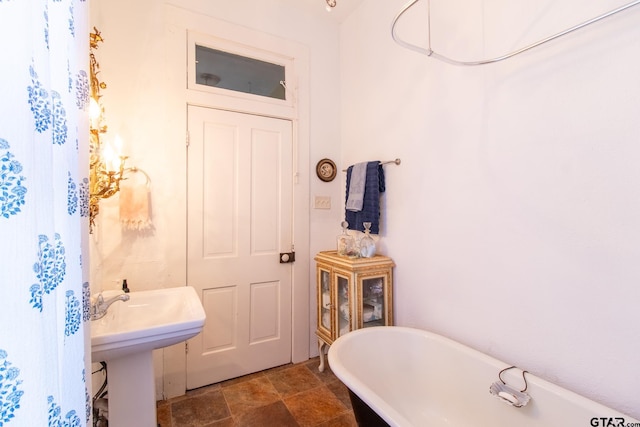 bathroom featuring a tub and sink