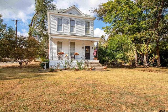 view of front facade with covered porch and a front yard