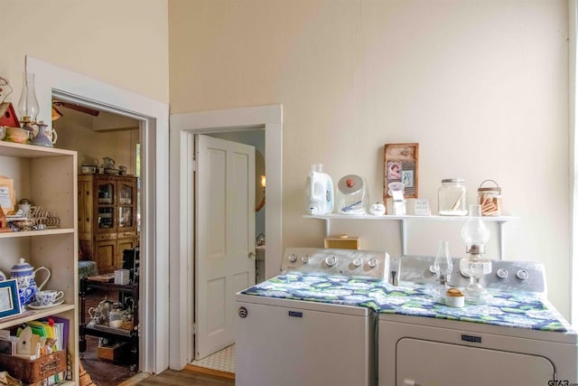 laundry area featuring light hardwood / wood-style floors and washer and clothes dryer