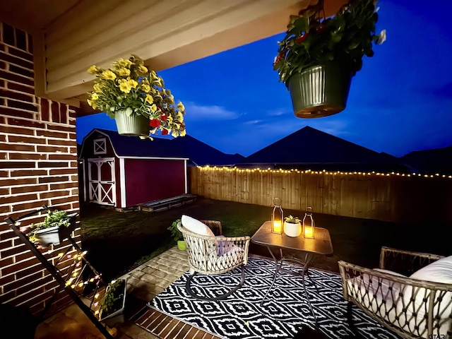 1625 Skidmore Ln, Tyler, TX 75703 - patio at night featuring a fenced backyard and a patio