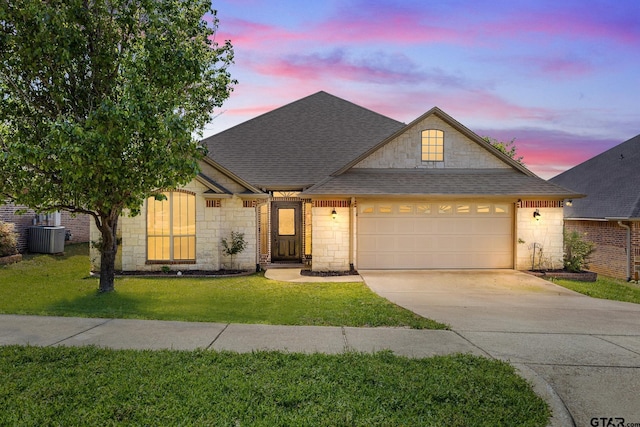 1625 Skidmore Ln, Tyler, TX 75703 - traditional home featuring stone siding, concrete driveway, an attached garage, and a shingled roof