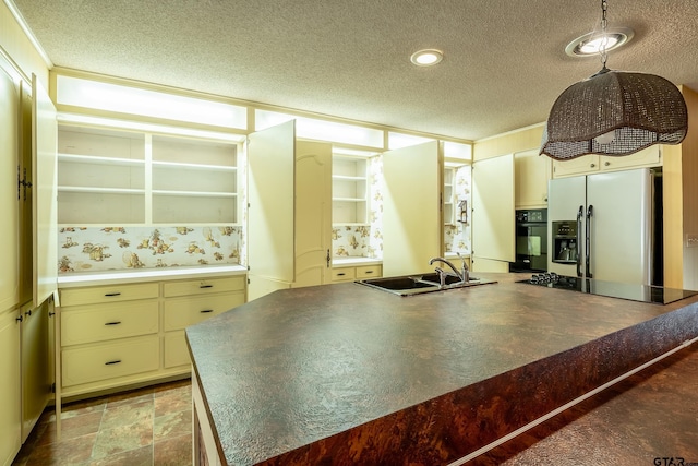 kitchen with black appliances, sink, hanging light fixtures, and a textured ceiling