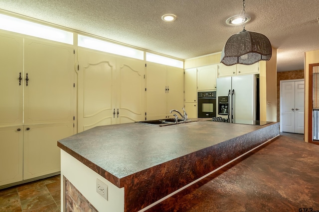 kitchen featuring a textured ceiling, sink, a center island, and black appliances