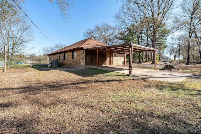 view of property exterior with a yard and a carport