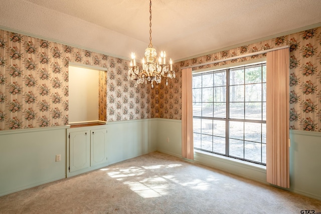 unfurnished dining area featuring a textured ceiling, a notable chandelier, and light carpet