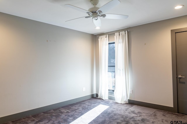 carpeted empty room featuring ceiling fan