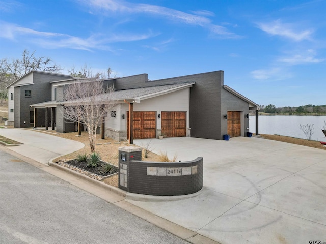 view of front of house with a garage and a water view