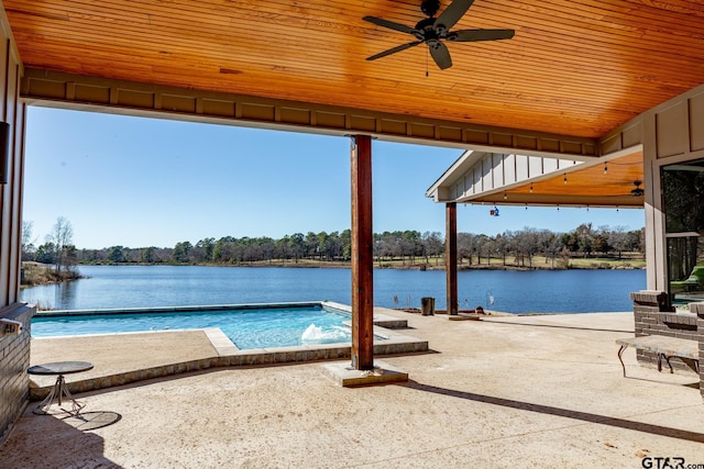 view of pool featuring a water view, ceiling fan, and a patio area