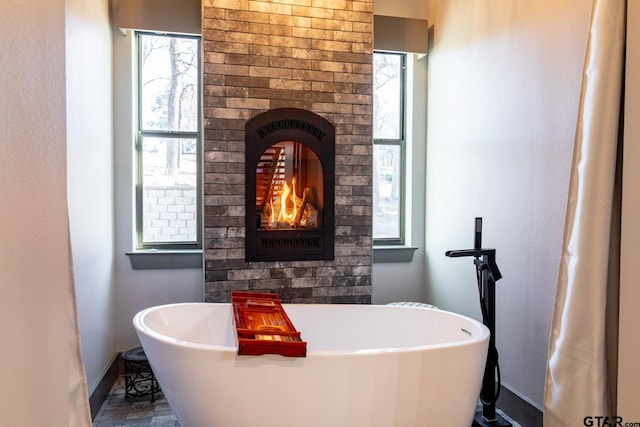 bathroom featuring a wealth of natural light and a bathtub