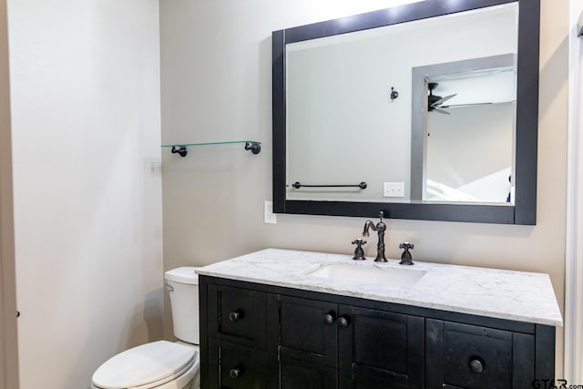 bathroom featuring ceiling fan, vanity, and toilet