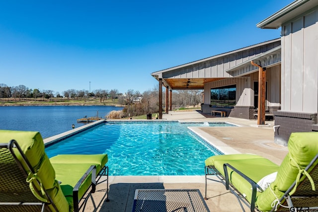 view of pool with a jacuzzi, ceiling fan, a patio, and a water view