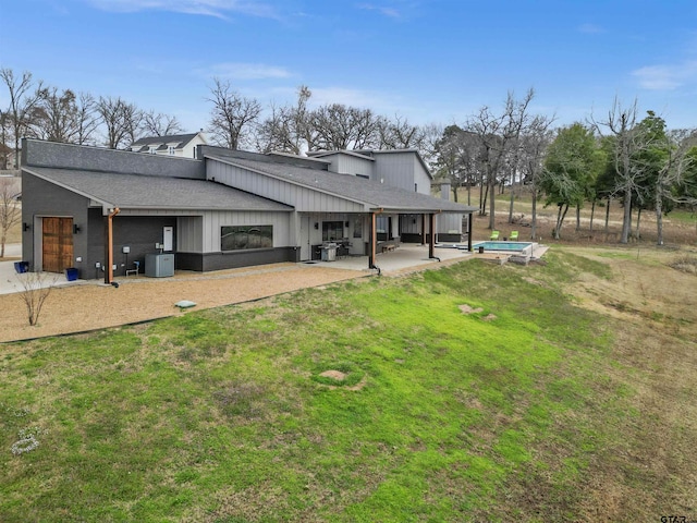 back of property featuring central AC unit, a lawn, and a patio