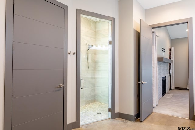 bathroom with a shower with door